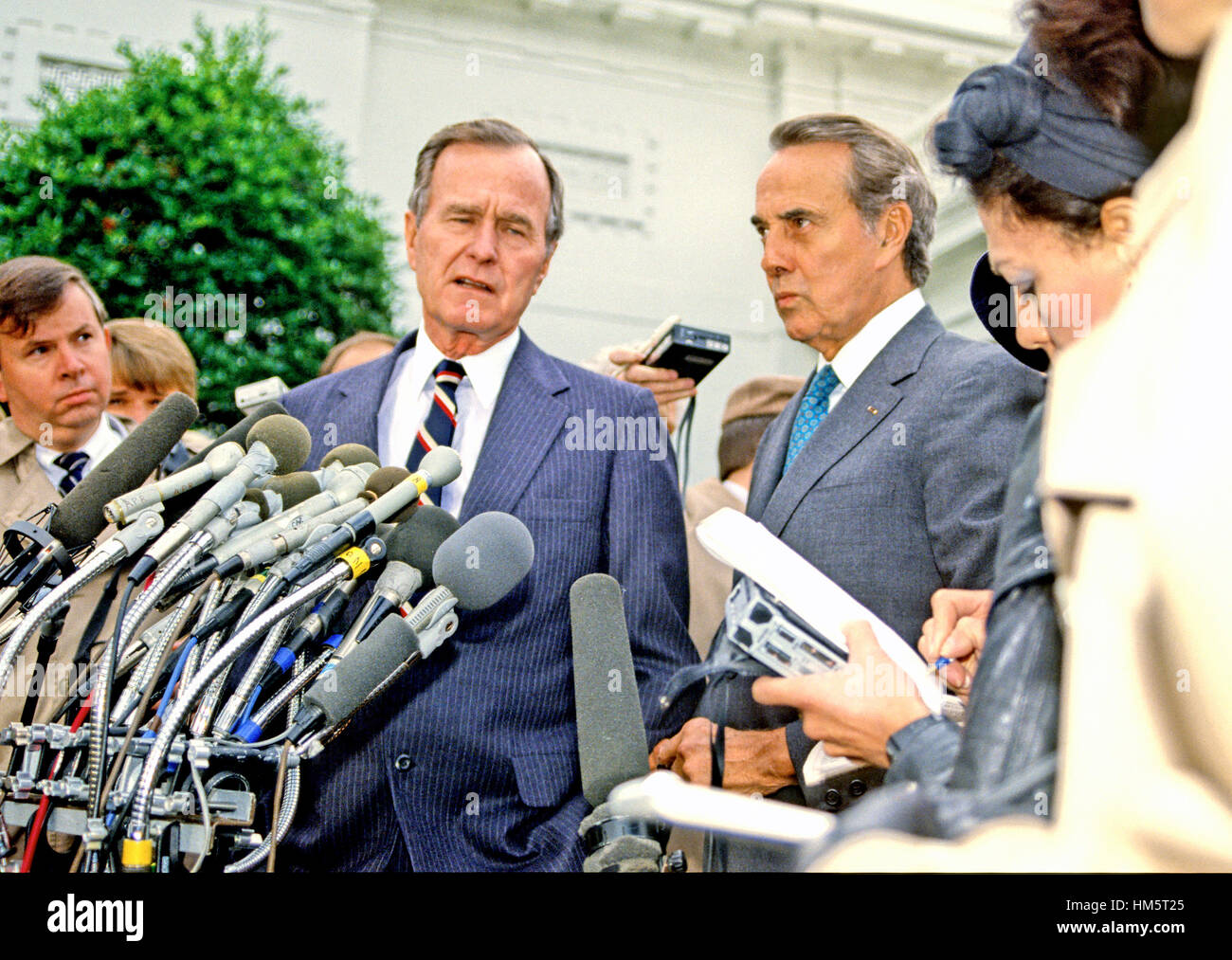 United States President-elect George H.W. Bush and U.S. Senate Republican Leader Bob Dole (Republican of Kansas) meet reporters at the White House in Washington, D.C. following their luncheon meeting on November 28, 1988. Stock Photo