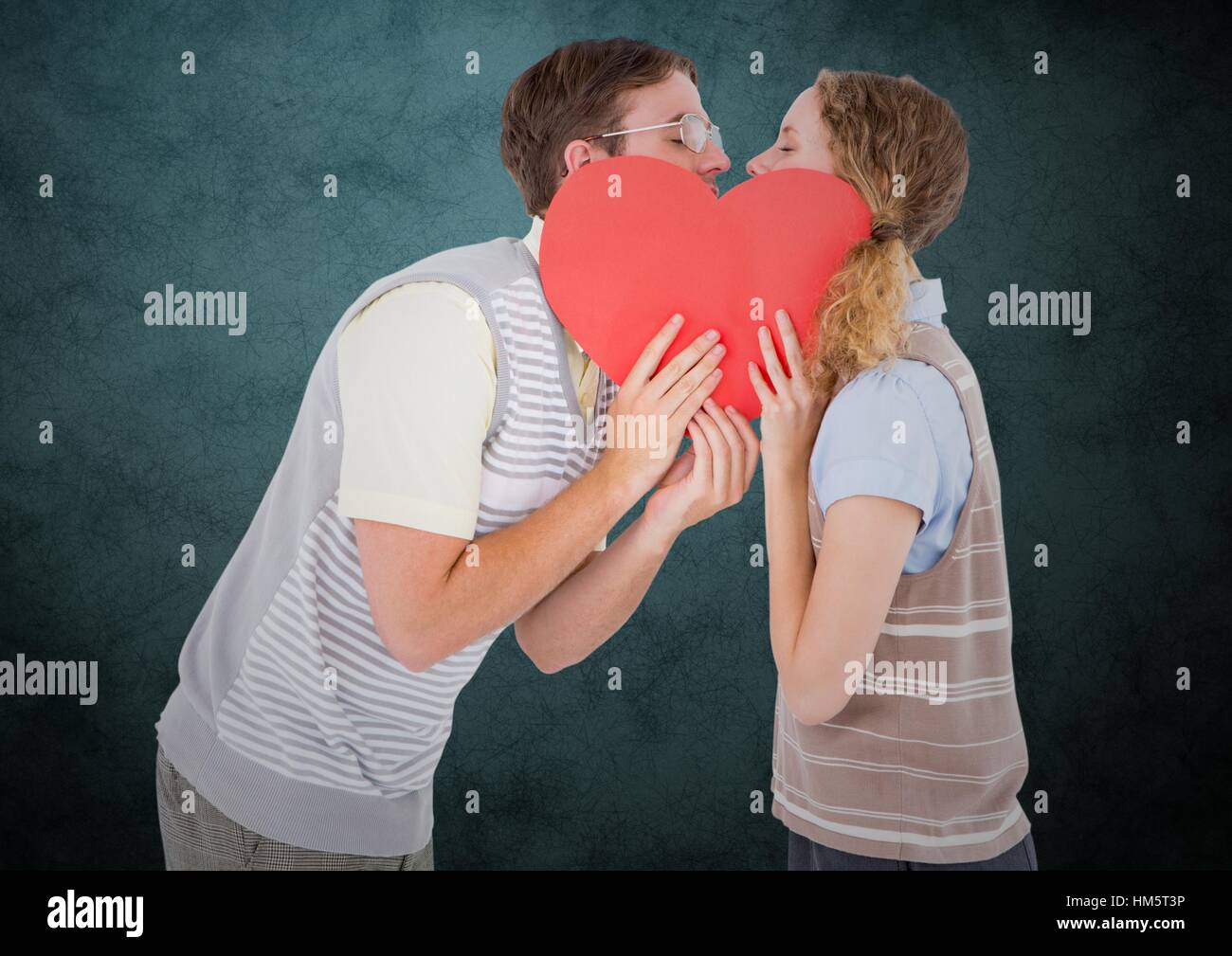 Romantic couple kissing behind heart Stock Photo - Alamy
