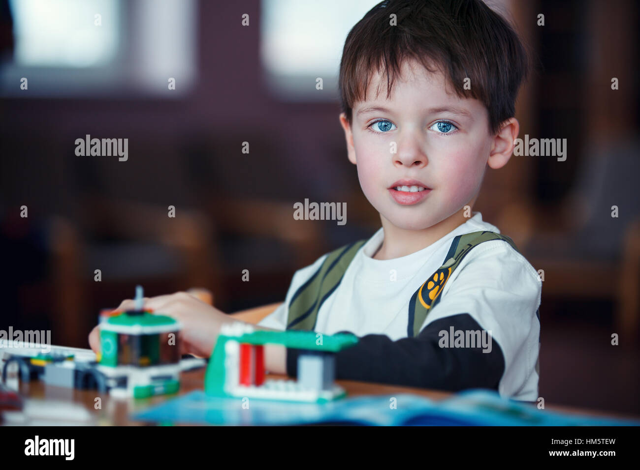 Concentrated child reading a manual Stock Photo