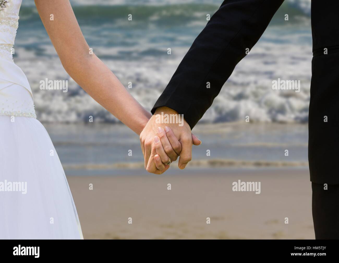 Newly wed couple holding hands Stock Photo