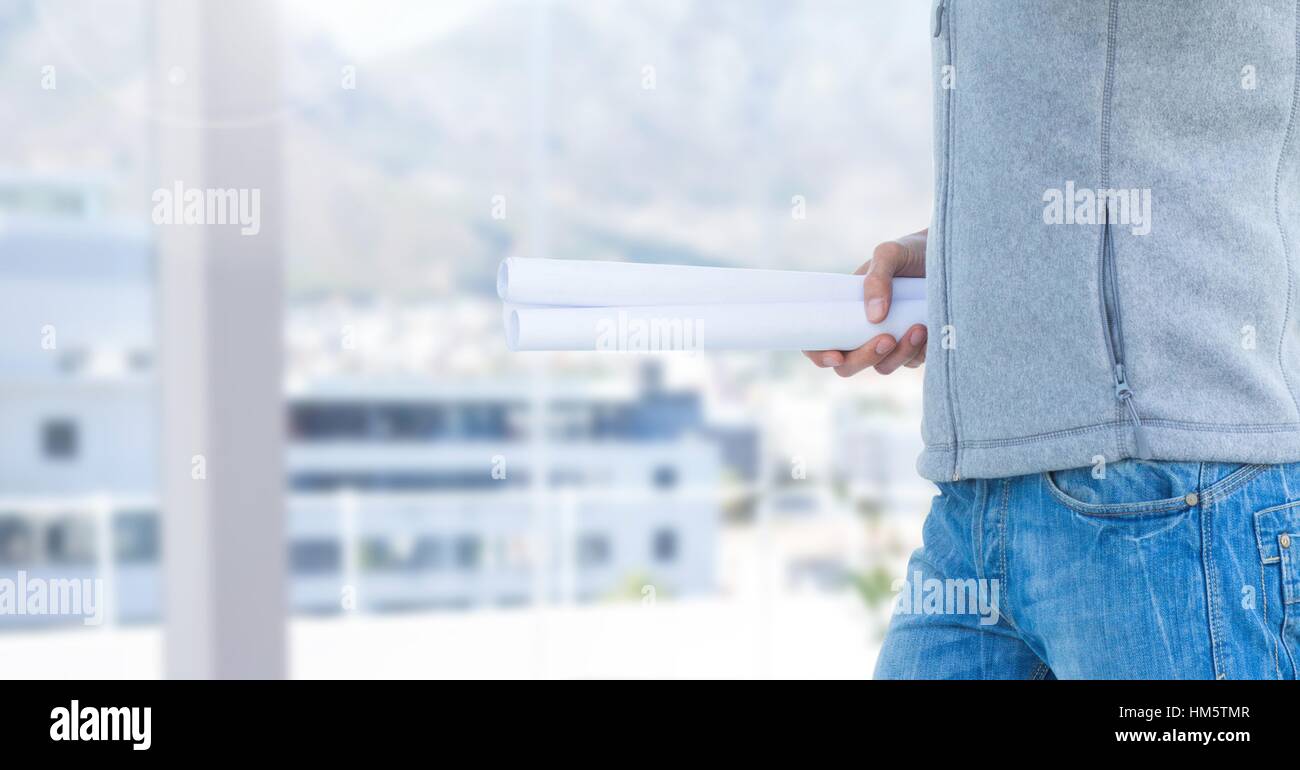 Construction man holding blueprint Stock Photo - Alamy