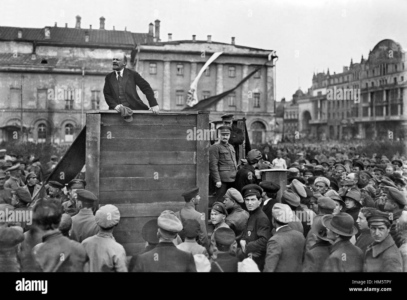 VLADIMIR LENIN (1870-1924) making a speech in  Sverdlov Square, Moscow, 5 May 1920. On the steps to the right stands Trotsky with Kamenev behind him. Under Stalin's orders the latter two were edited out of the photo. Stock Photo