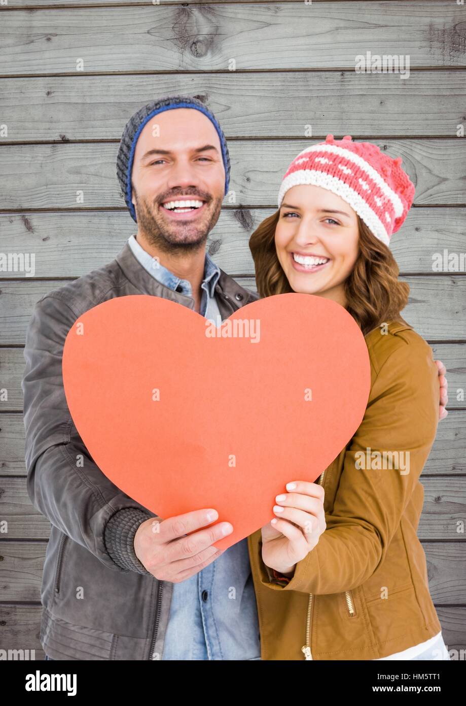 Romantic couple holding a heart Stock Photo - Alamy