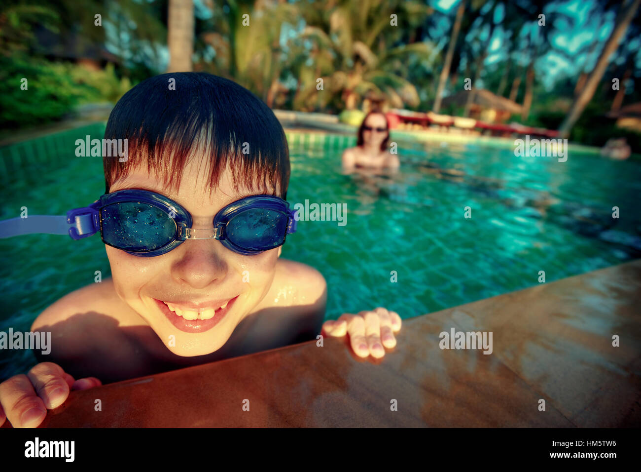 Cute little boy in swimming pool on exotic island Stock Photo