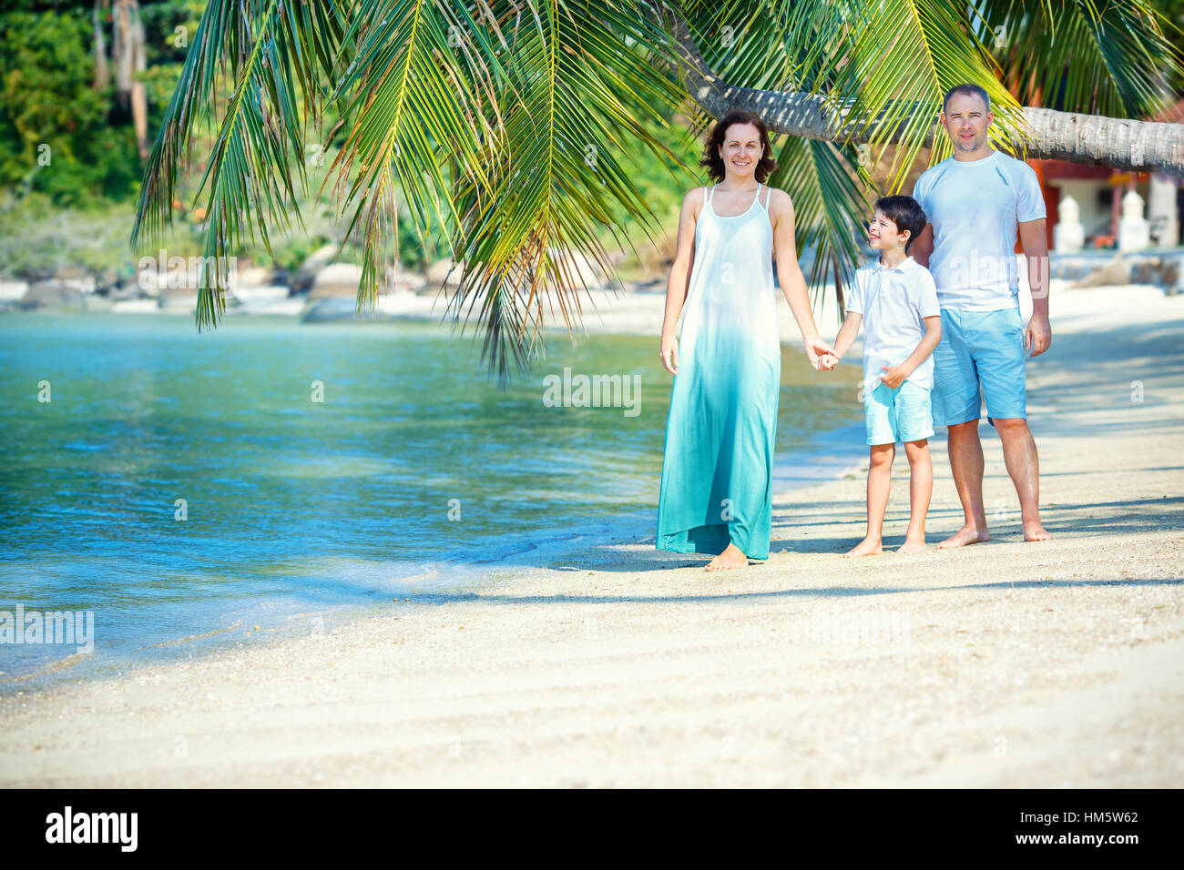 Young family of three having fun tropical beach, Koh Phangan island, Thailand Stock Photo