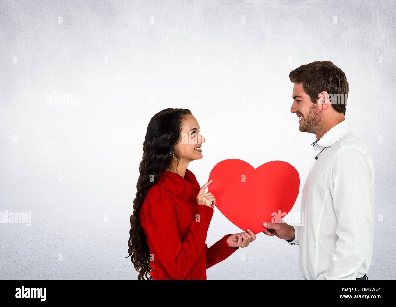 Smiling couple holding heart Stock Photo - Alamy