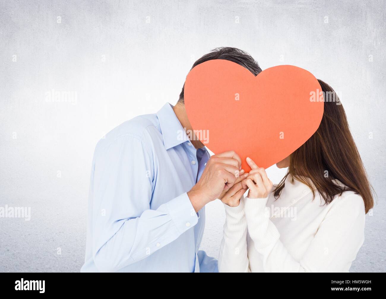 Romantic couple holding heart shape and kissing each other Stock Photo ...