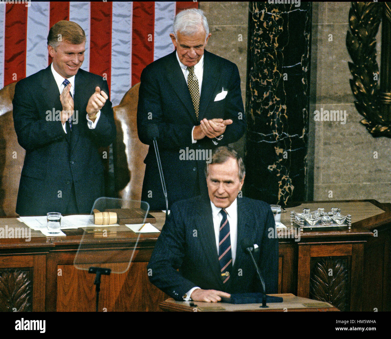 United States President George H.W. Bush speaks to a Joint Session of the U.S. Congress in the U.S. House Chamber in the Capitol in Washington, D.C. to report on the victory over Iraq in the Gulf War on March 6, 1991. U.S. Vice President Dan Quayle, left, Stock Photo