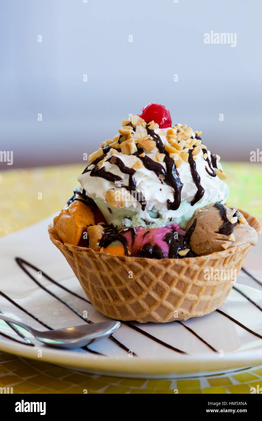 Colorful ice cream sundae with hazelnuts and whipped cream Stock Photo