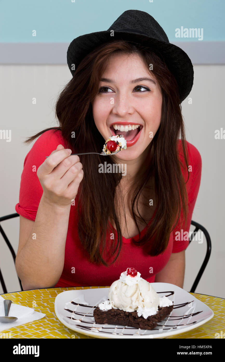 Young woman eating brownie Stock Photo
