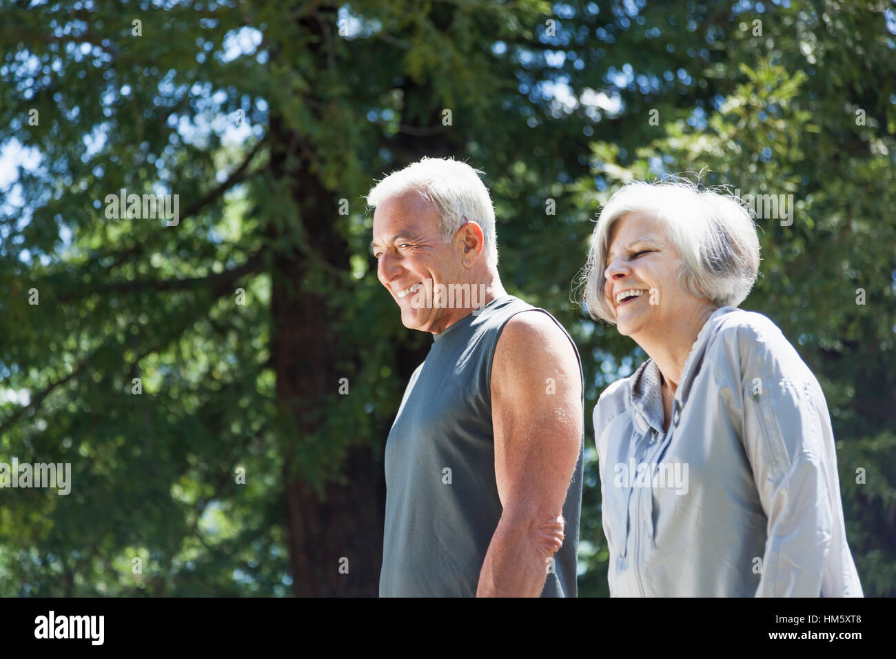 Senior couple walking in forest Stock Photo