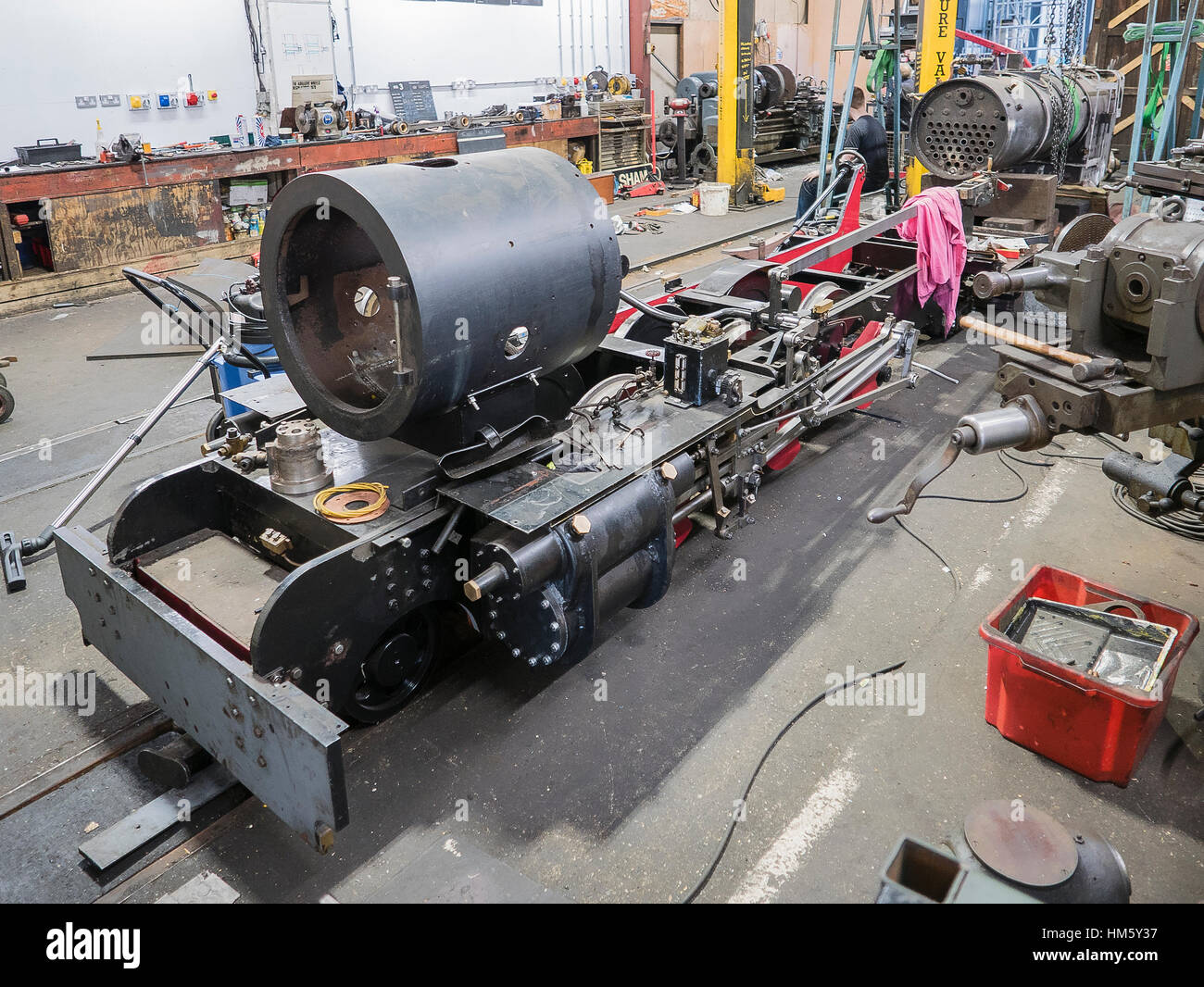 Inside the Bure Valley Railway maintenance workshops showing a partly dismantled locomotive in Aylsham Norfolk UK Stock Photo