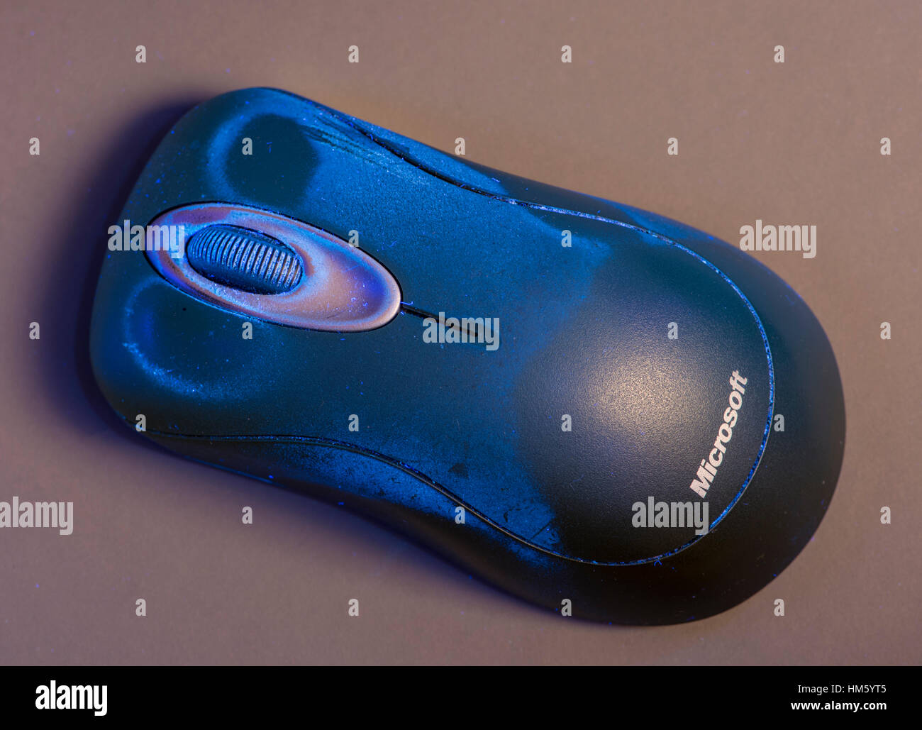 Computer mouse, fluorescing in UV light, showing dirt on surface Stock Photo