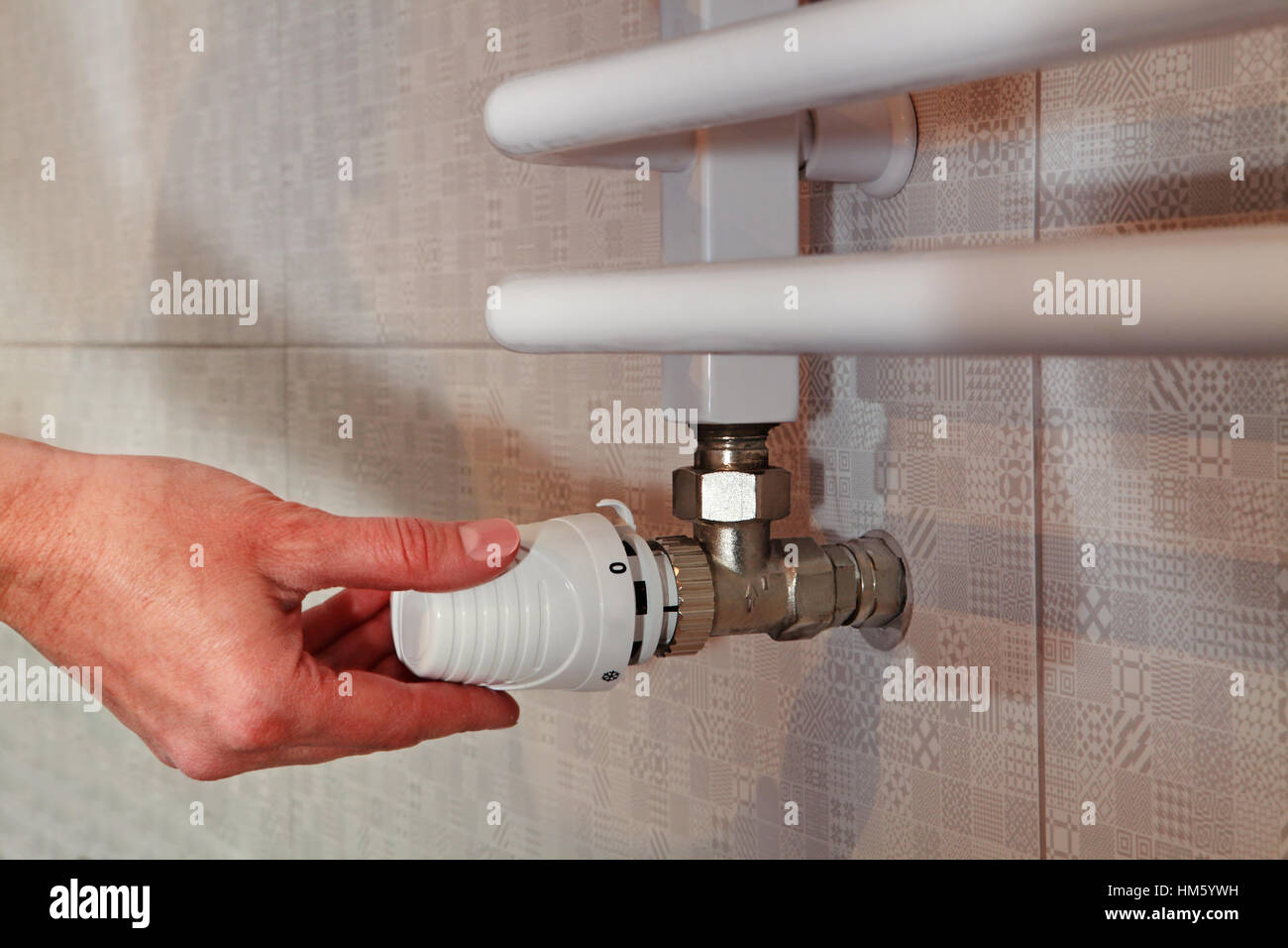 hand make temperature regulation on heated towel rail Stock Photo Alamy