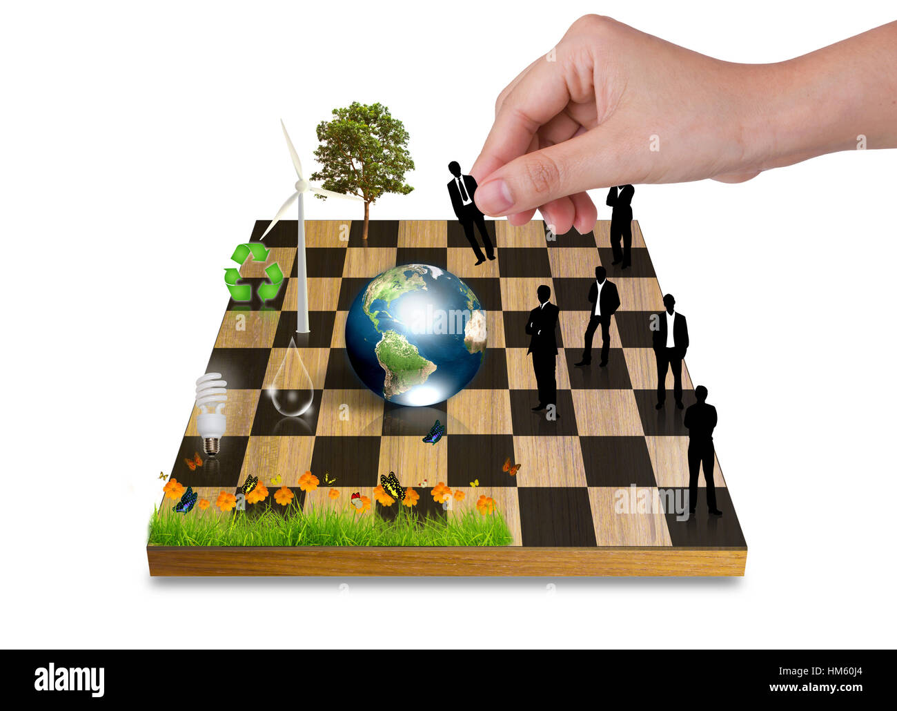 Hand Playing chess game with Silhouettes of business people vs nature tree,earth,Wind turbines,flowerbulb) (Elements of this image furnished by NASA Stock Photo - Alamy