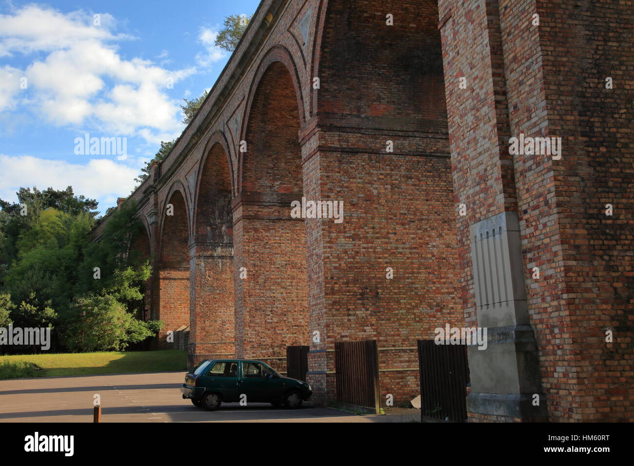 Weed growth on Victorian brick built railway viaduct archways across the Bourne Valley and Surrey Road at Branksome between Bournemouth and Poole UK Stock Photo