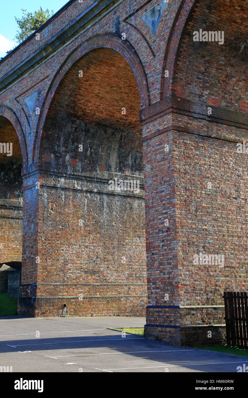 Weed growth on Victorian brick built railway viaduct archways across the Bourne Valley and Surrey Road at Branksome between Bournemouth and Poole UK Stock Photo