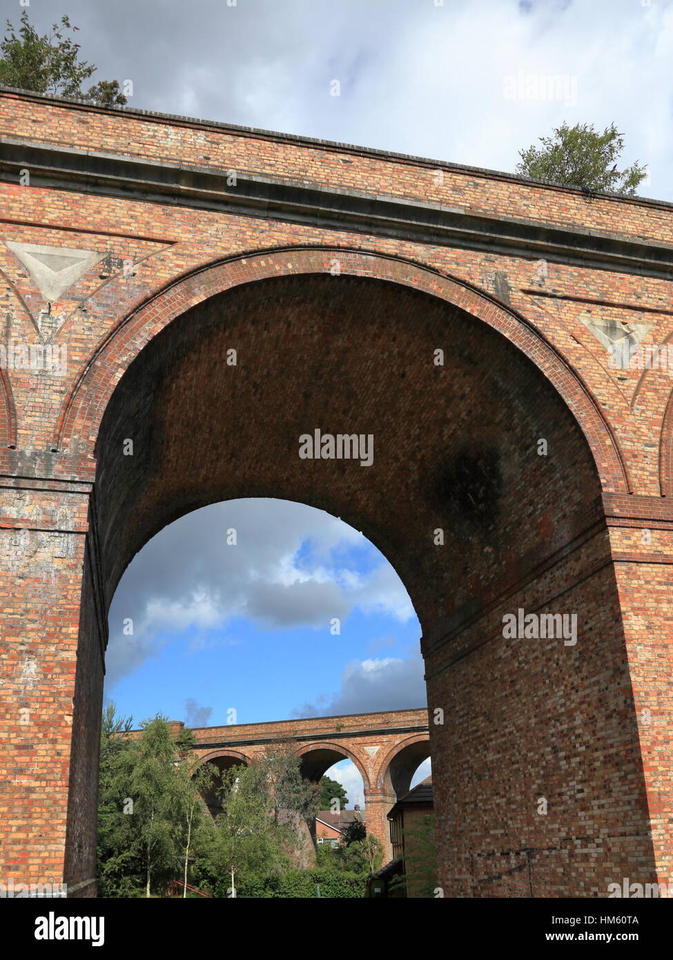 Weed growth on Victorian brick built railway viaduct archways across the Bourne Valley and Surrey Road at Branksome between Bournemouth and Poole UK Stock Photo