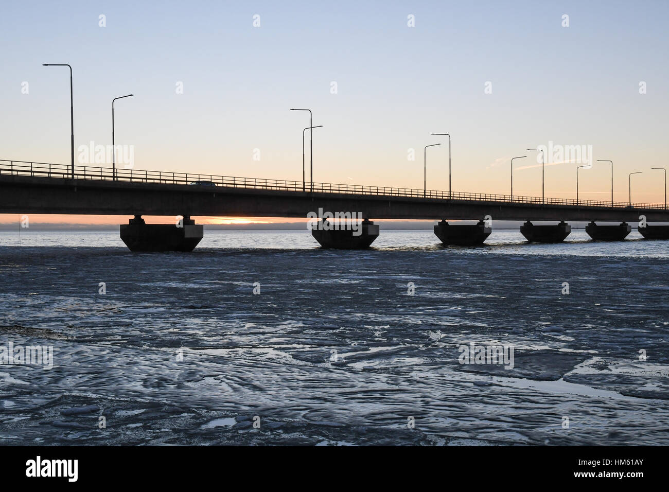 Ice floe in front of a detail of the Oland bridge, connecting the island Oland with mainland Sweden Stock Photo