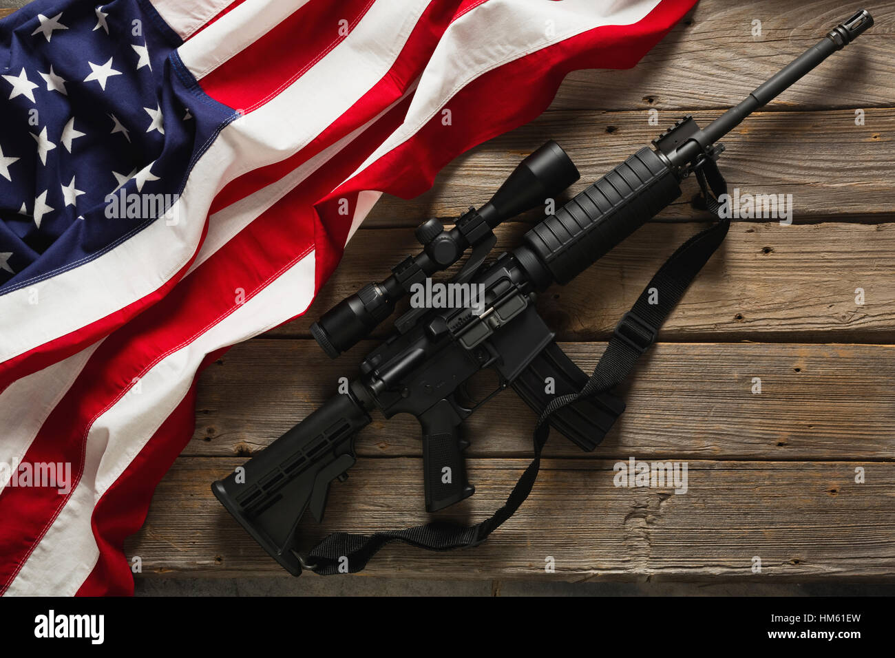 American flag and rifle against wooden wall Stock Photo