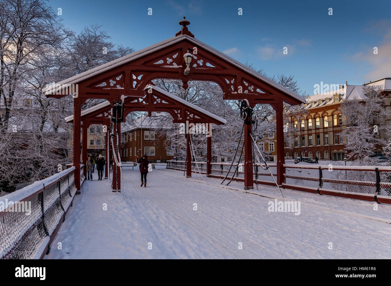 Gamle bybro, the old town bridge over the river Nid in Trondheim, Norway. The view is seen in Winter with blue sky. Stock Photo