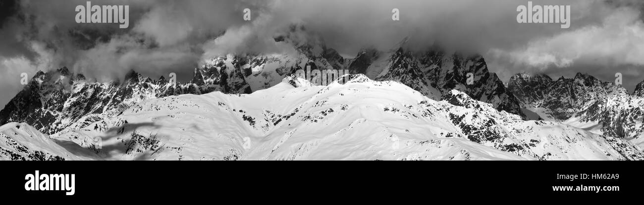 Black and white panoramic view on Mounts Ushba and Chatyn in haze at sunny day. Caucasus Mountains. Svaneti region of Georgia. Stock Photo
