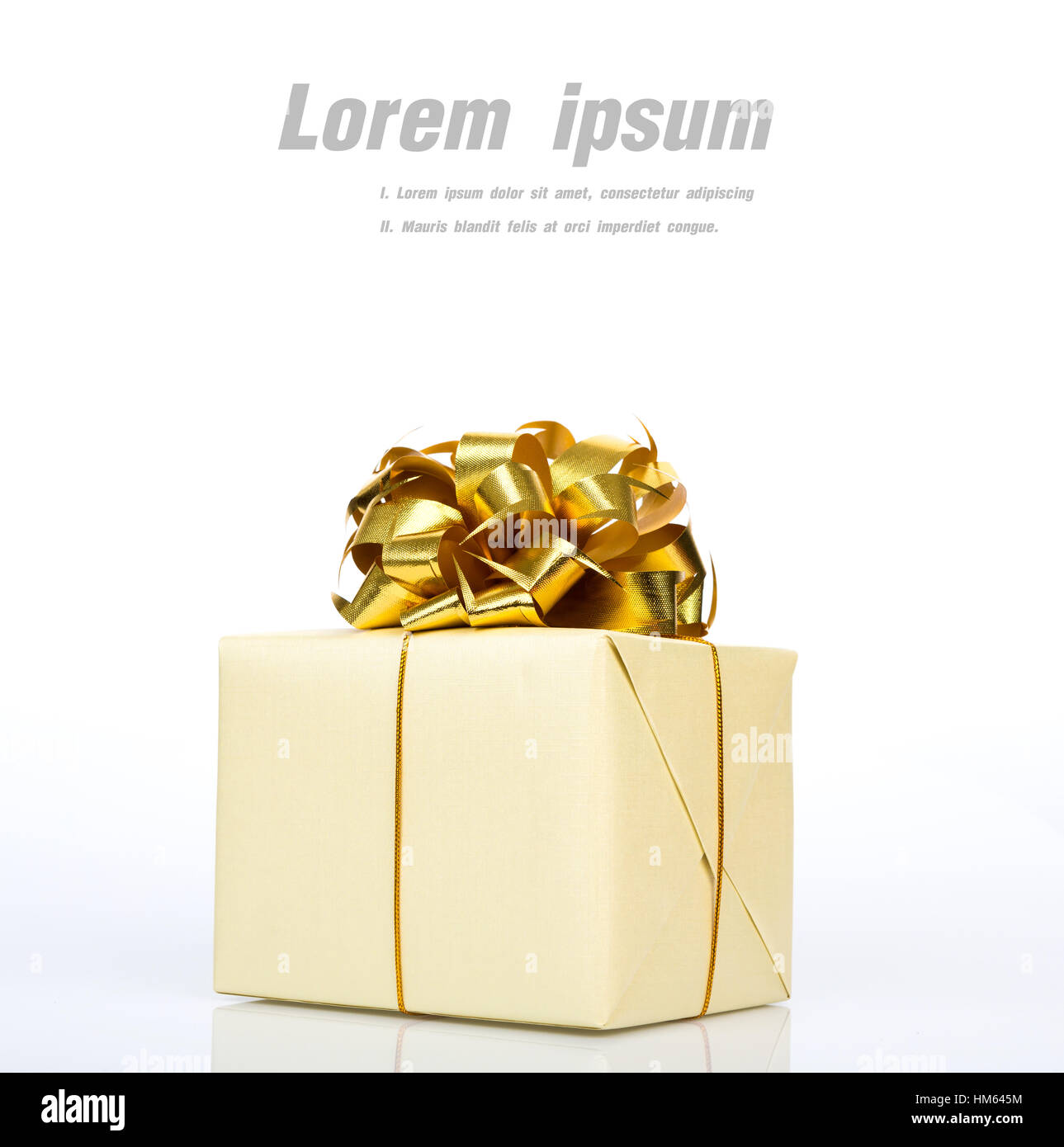 Gold gift box with ribbon on white background Stock Photo - Alamy