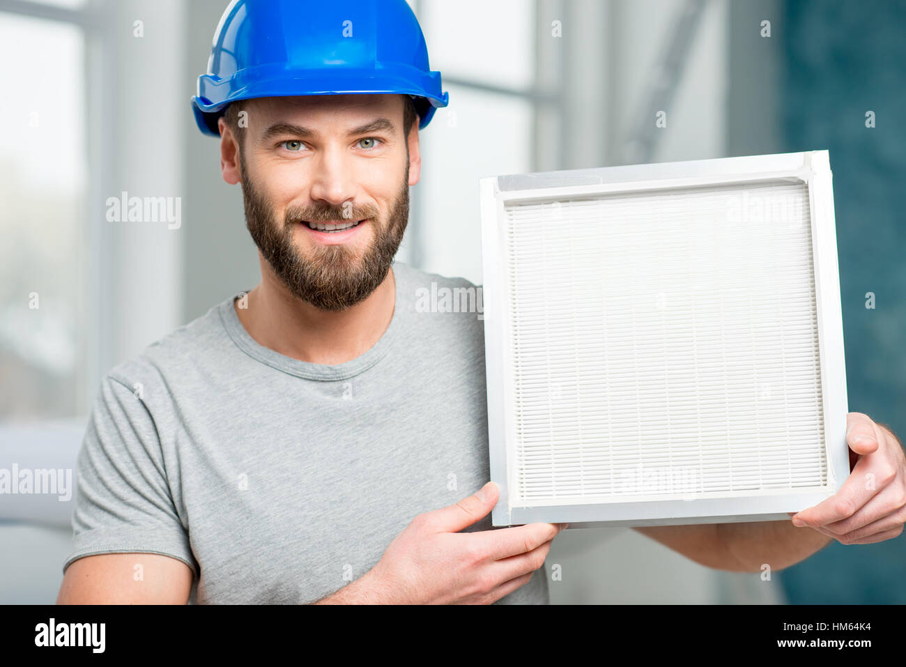 Worker with air filter Stock Photo