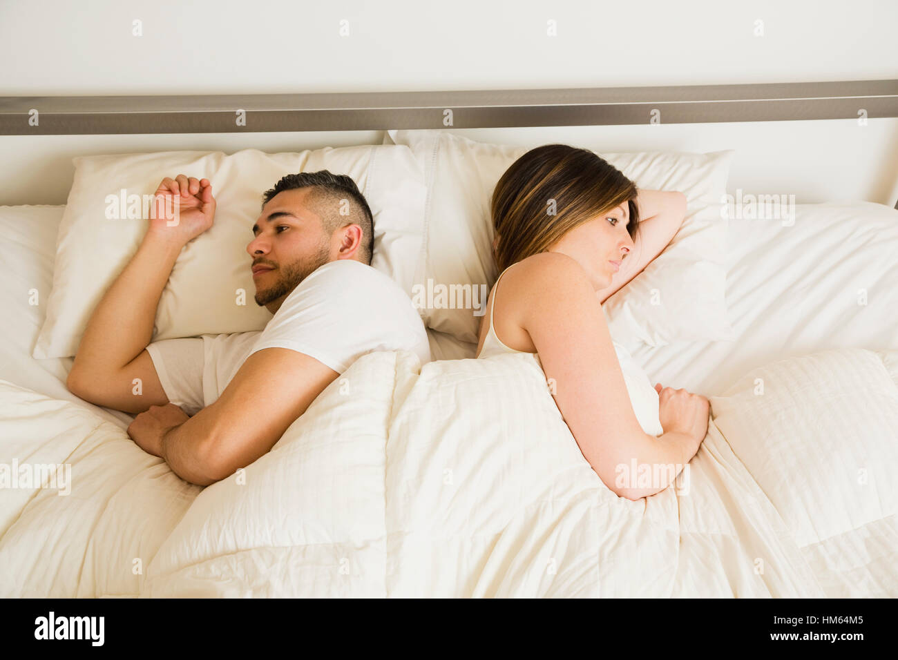 Young couple lying in bed Stock Photo