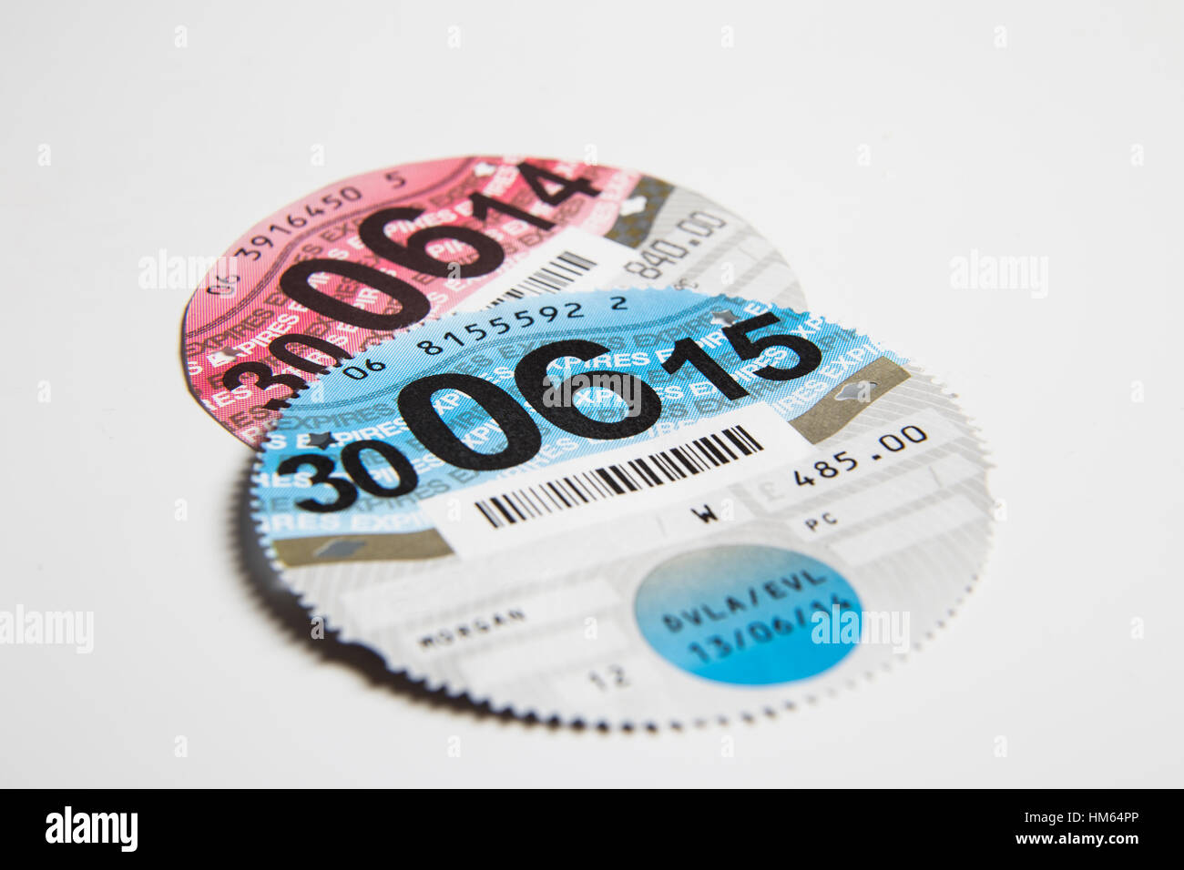 Old round British Car Tax Discs that used to go in the windscreen. Stock Photo