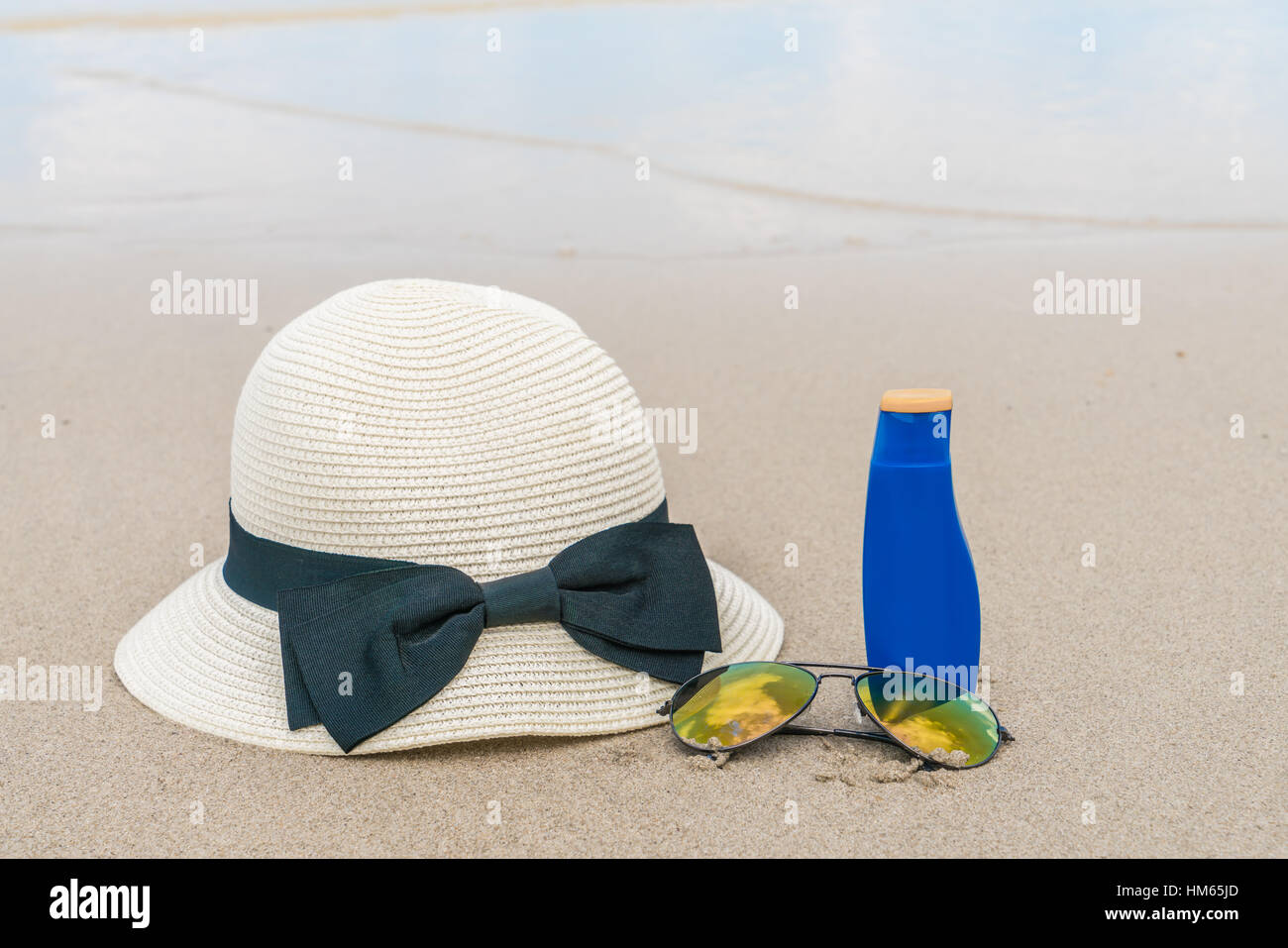 Sunglasses, sun cream and hat on white sand beach Stock Photo Alamy