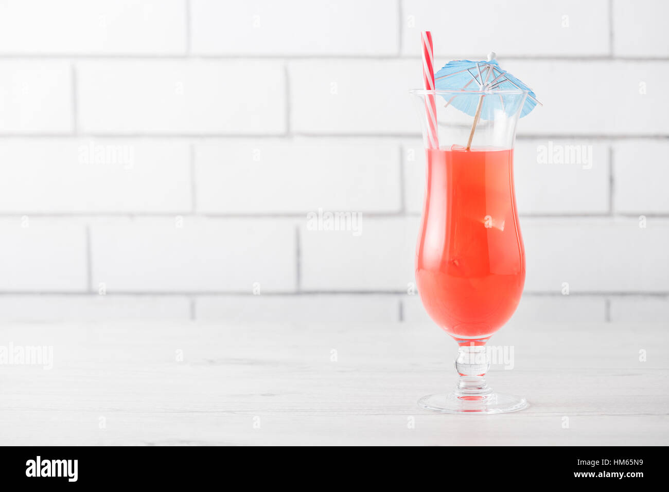 Fresh home made Singapore Sling with cocktails umbrella Stock Photo