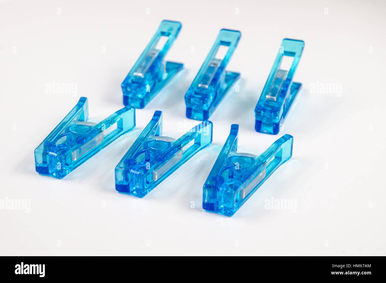 Blue plastic clothespins on white background Stock Photo Alamy