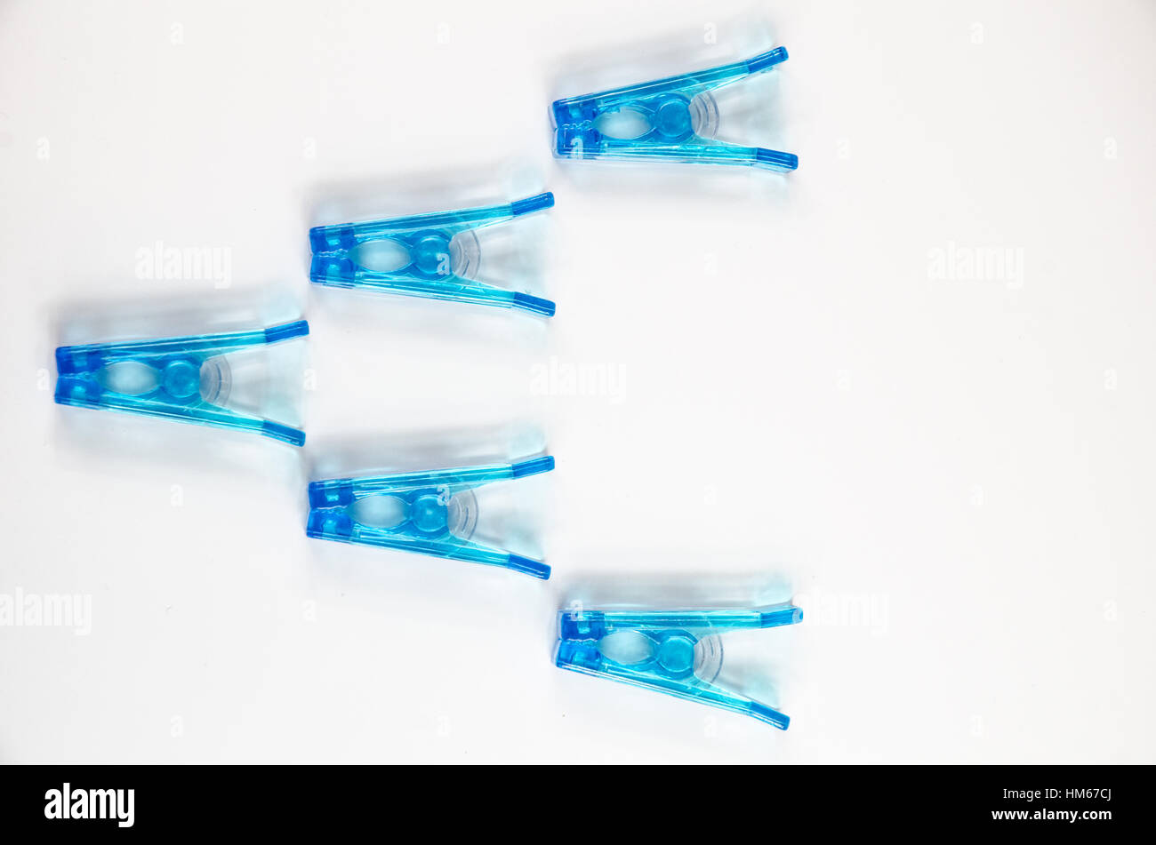 Blue plastic clothespins on white background Stock Photo Alamy