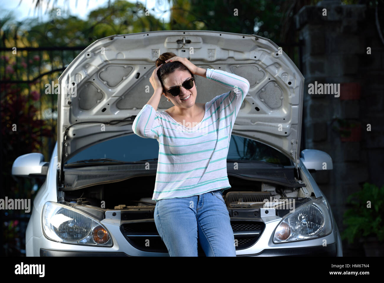 worried girl with her broken car and waiting Stock Photo