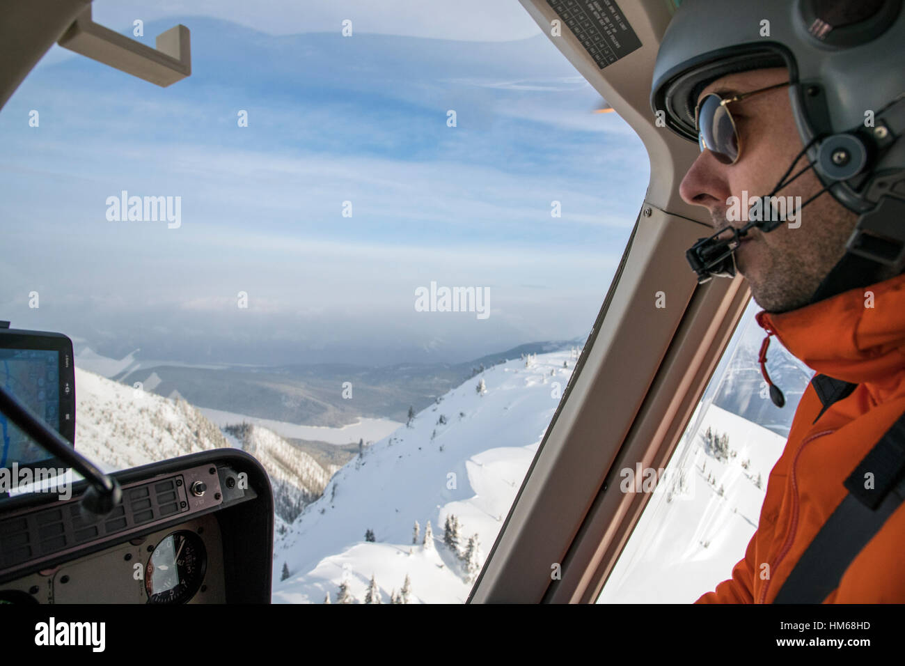 Helicopter pilot flying over Esplanade Range; sub-range of Selkirk Range; British Columbia; Canada Stock Photo