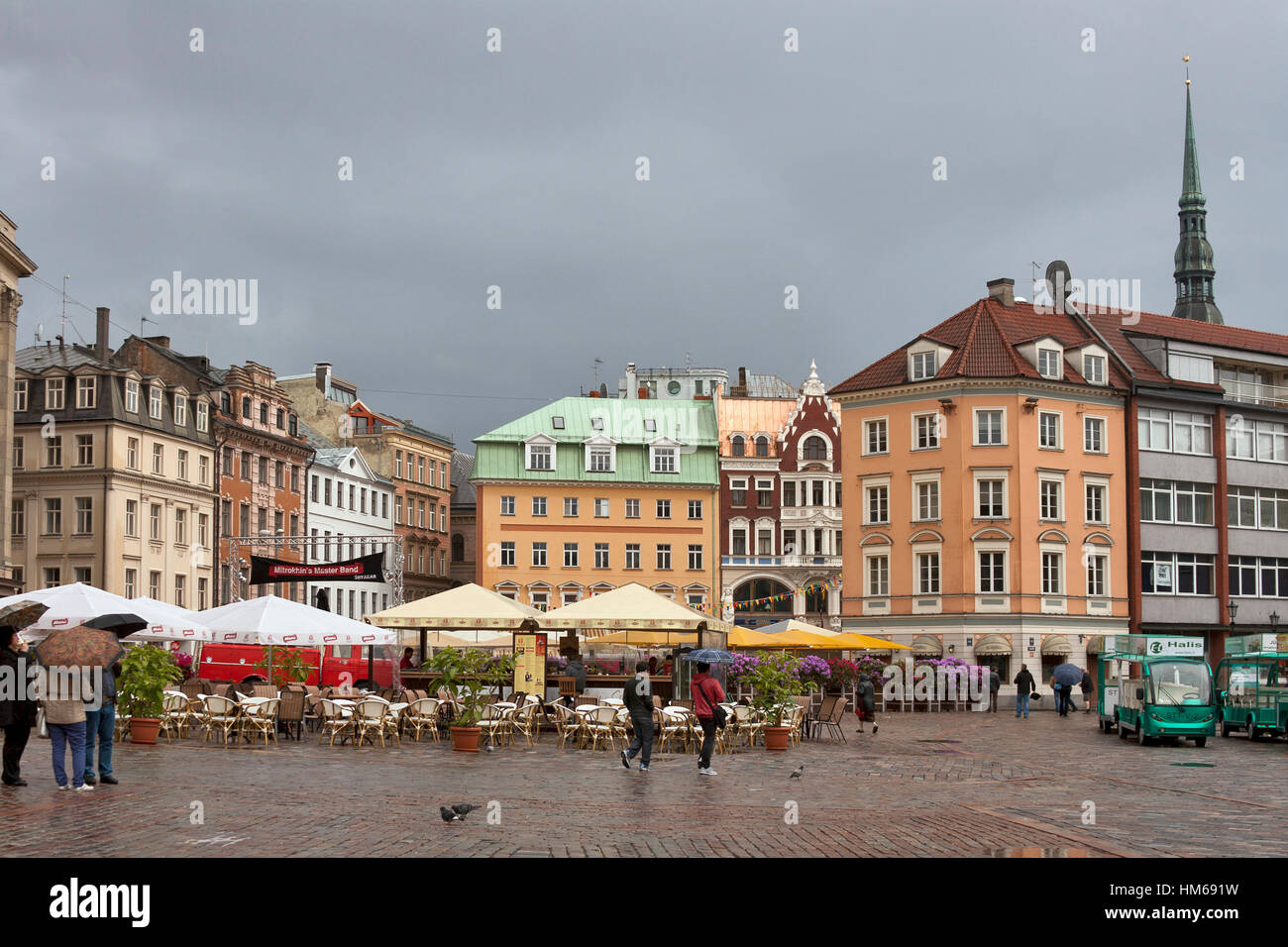 RIGA, LATVIA - JUNE 2: Pedestrians walk under the rain on Dome Square on  June 2, 2012 in Riga, Latvia. The Dome Square is considered to be the heart  o Stock Photo - Alamy