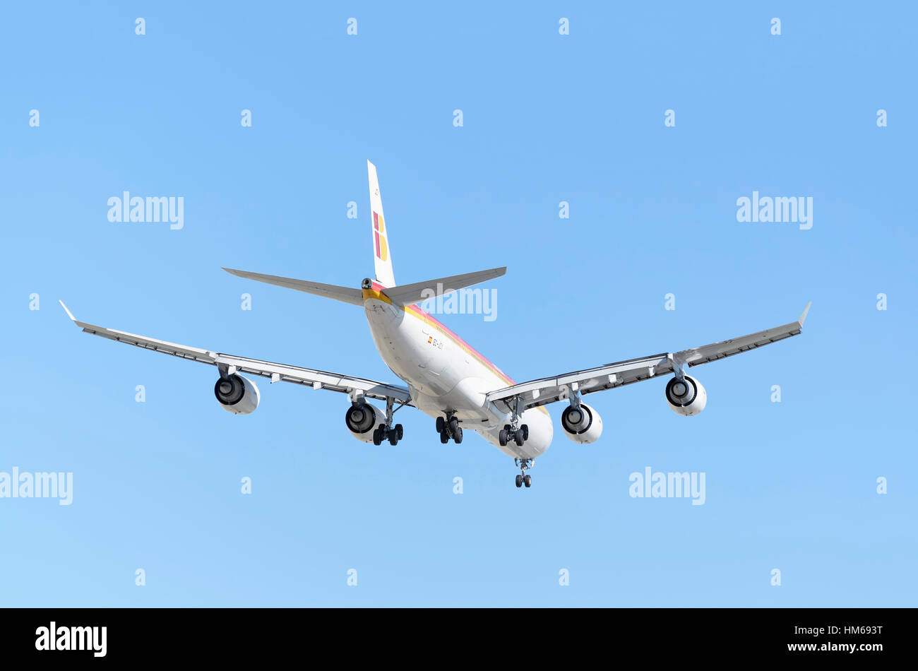 Airplane Airbus A340, of Iberia airline. Rear view. Blue sky. Stock Photo