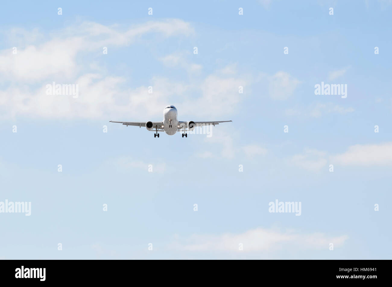 Airplane Airbus A320, of Iberia airline. Blue sky with some clouds. Stock Photo