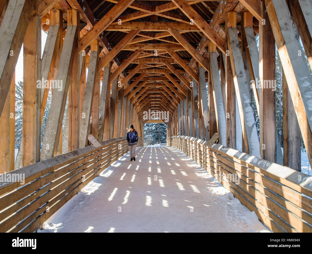 Lone pedestrian; Kicking Horse Pedestrian Bridge over Kicking Horse River; Golden; British Columbia; Canada Stock Photo