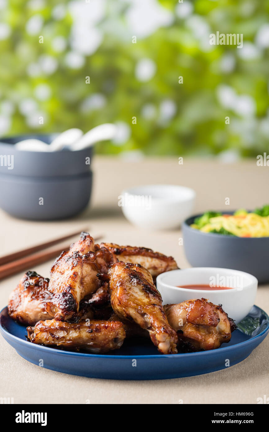 Barbecue chicken wings serves noodles with hot dipping sauce Stock Photo