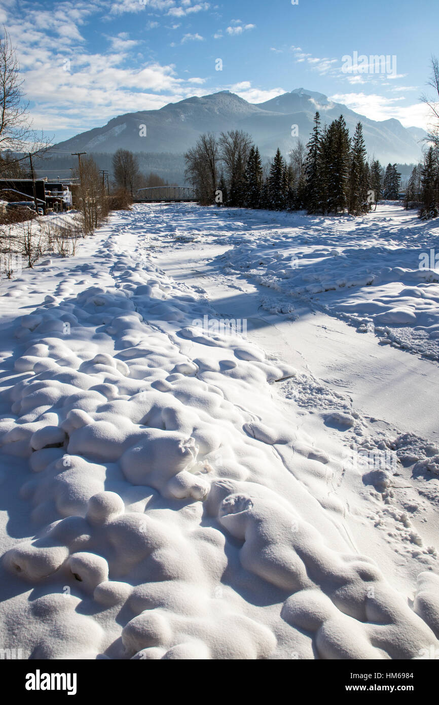 Snowy winter view of Kicking Horse River from Kicking Horse Pedestrian Bridge; Golden; British Columbia; Canada Stock Photo
