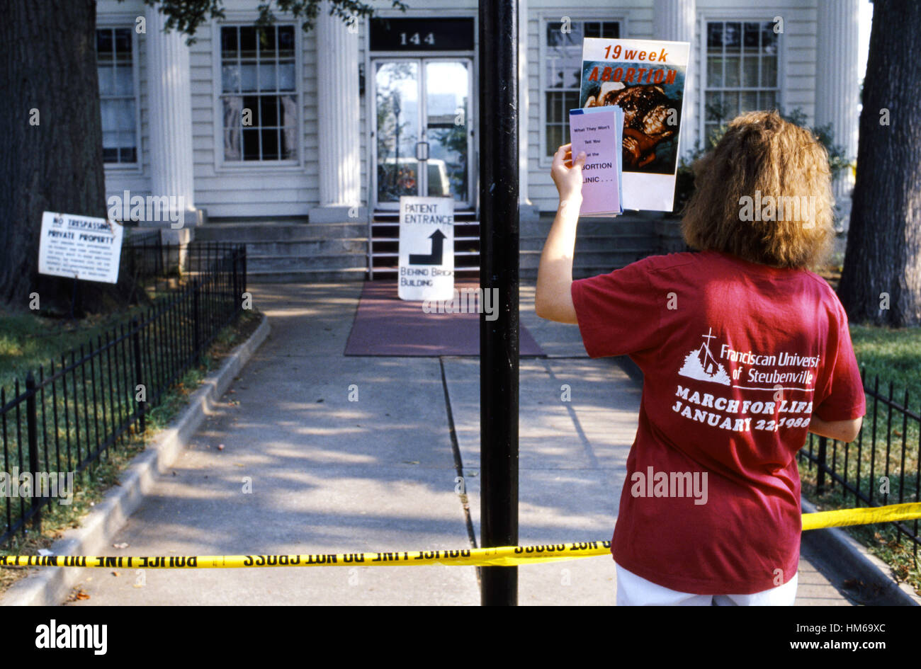 A lone pro life demonstrator at the police line outside an Atlanta family planning clinic and hospital Stock Photo