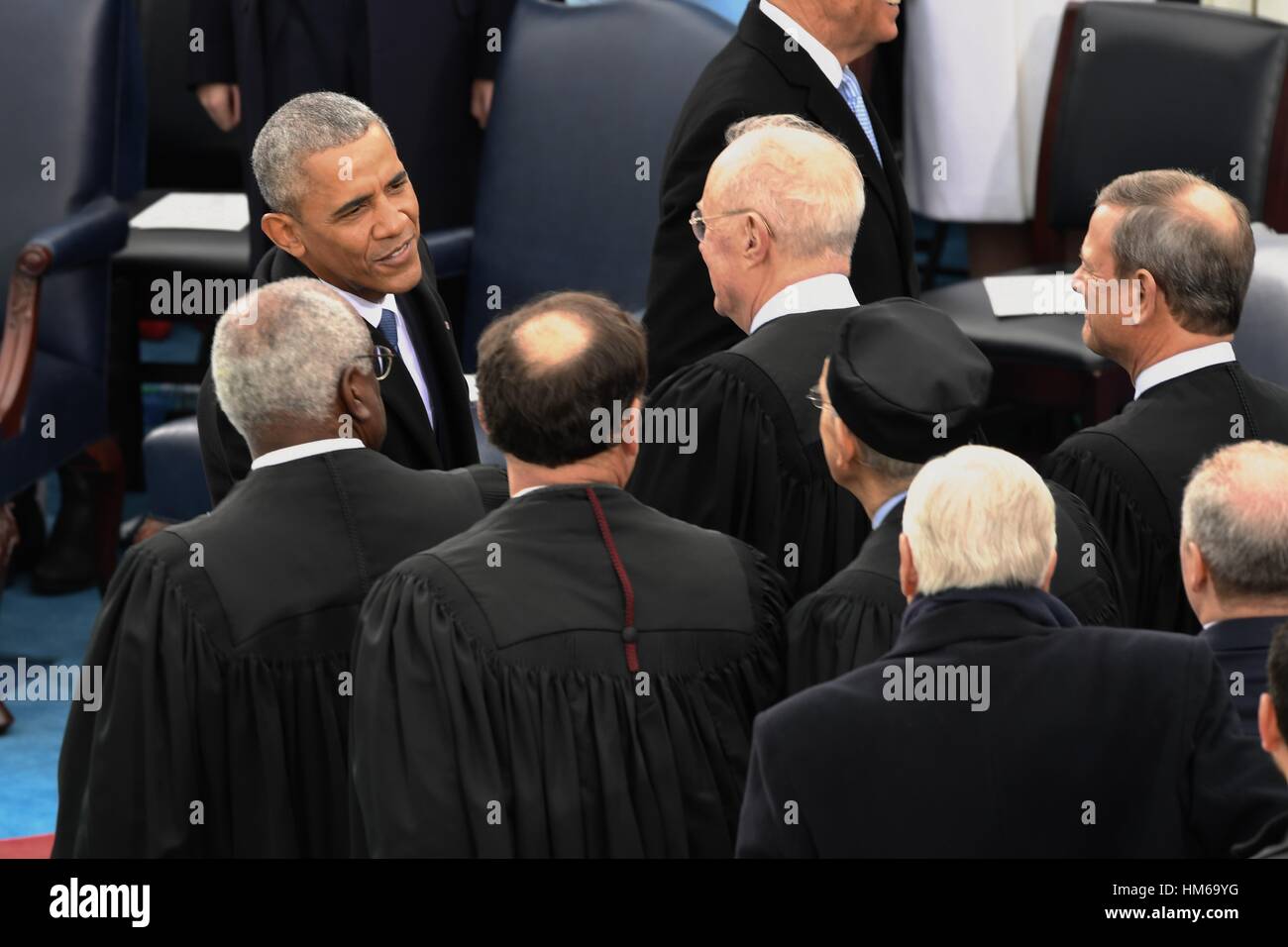 President Barack Obama greets justices of the Supreme Court after he arrived for the President Inaugural Ceremony on Capitol Hill January 20, 2017 in Washington, DC. Donald Trump became the 45th President of the United States in the ceremony. Stock Photo