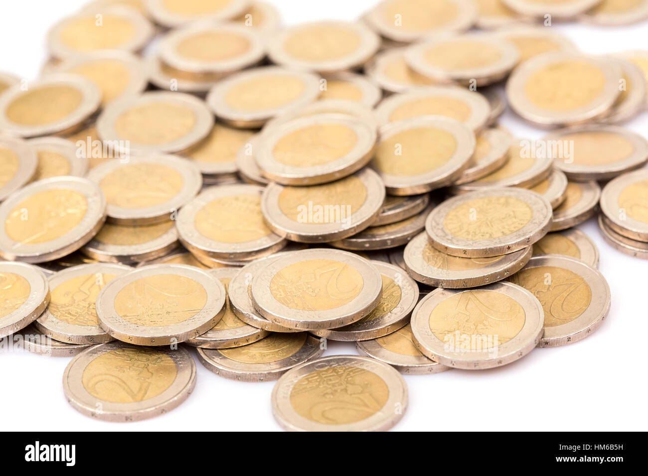 Heap of two euro coins isolated on white background Stock Photo - Alamy