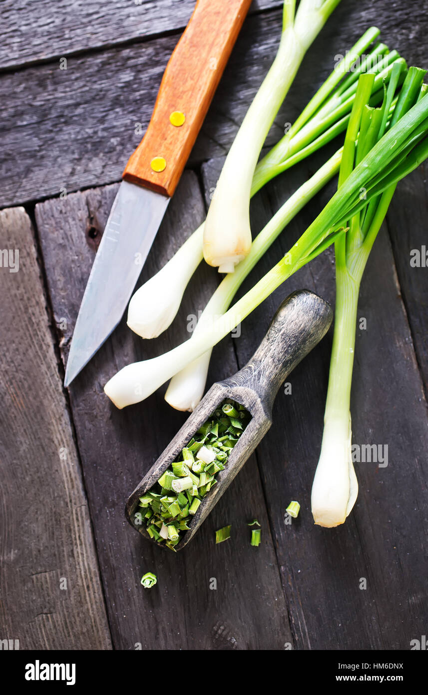 dry green onion and knife on a table Stock Photo - Alamy