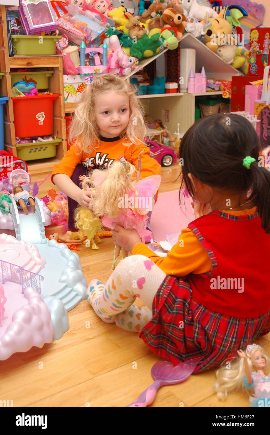 kids playing with barbie dolls