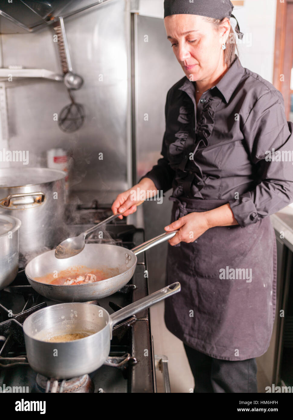 Chef Marina Morelli cooking in her restaurant Hosteria 700, Cremona