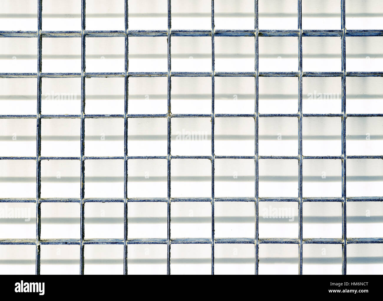 grid made of metal in quadratic partition with shadow, from above Stock Photo