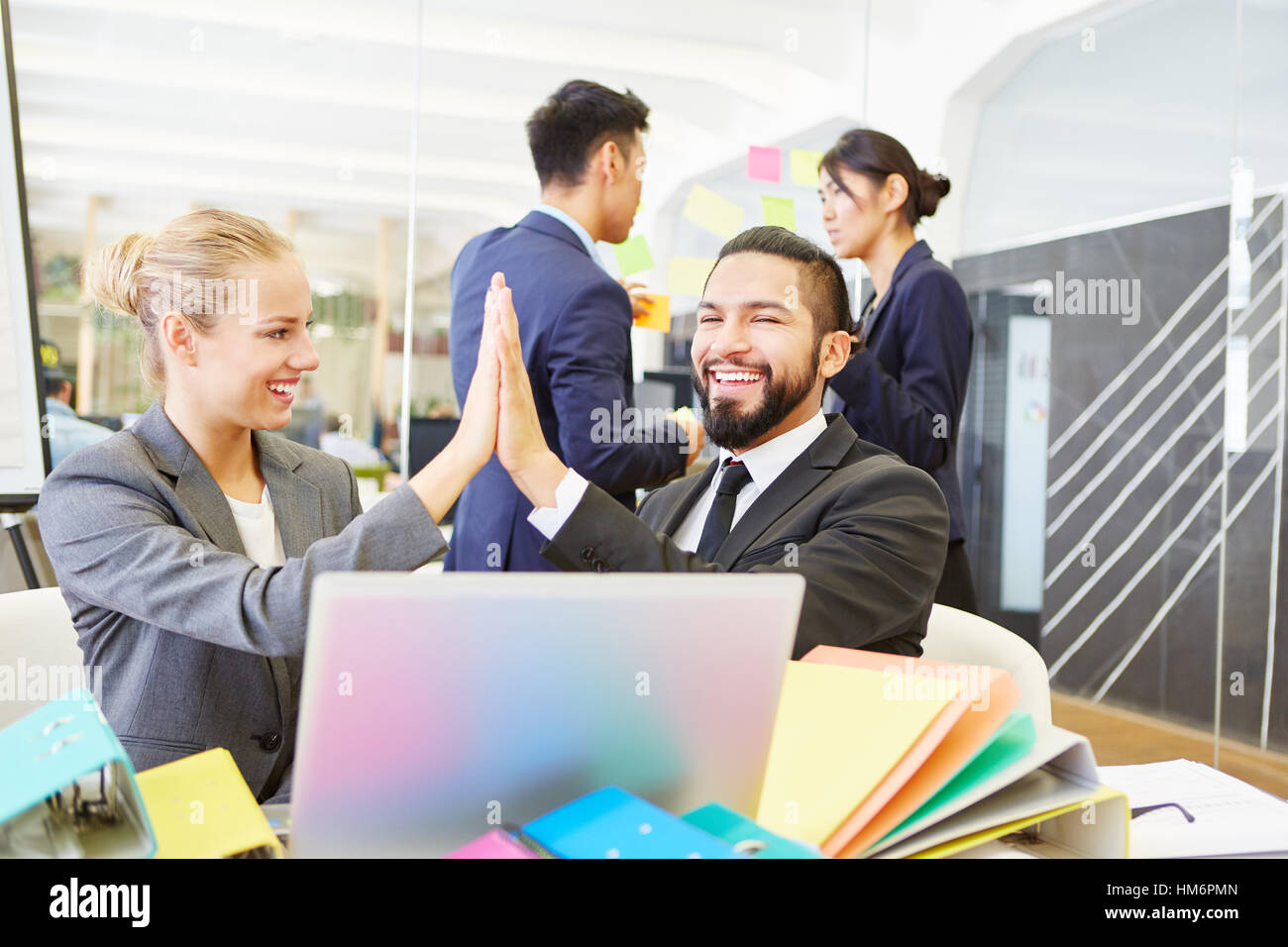 Two founds share High Five and celebrate their teamwork success Stock Photo